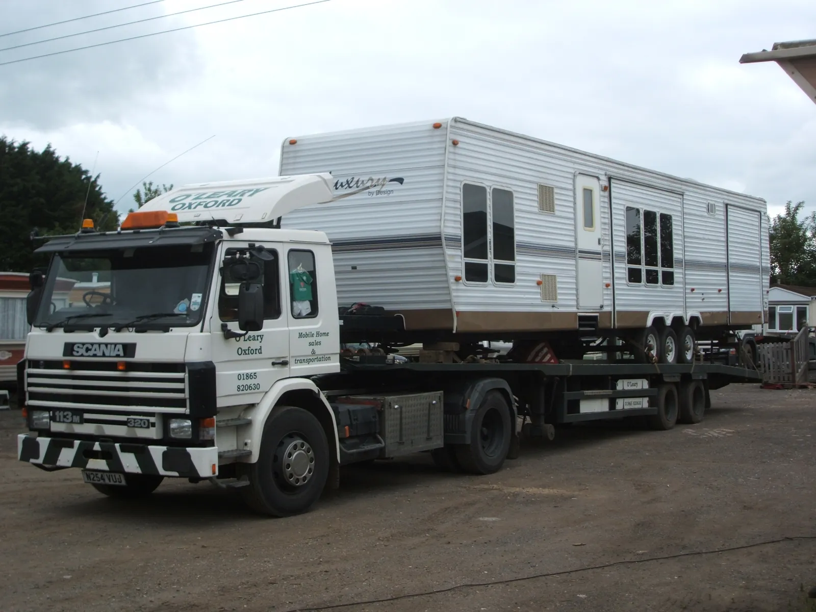 An O'Leary lorry carrying a large white mobile home
