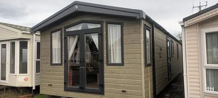 Swift Biarritz lodge exterior with French doors and a grey gable
